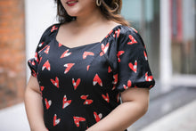 Load image into Gallery viewer, close up of plus size black and red heart print satin midi dress with puff sleeves
