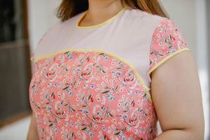 close up of plus size pink floral modern cheongsam qipao inspired shift dress with yellow piping