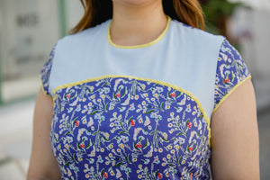 close up of plus size blue floral modern cheongsam qipao inspired shift dress with yellow piping