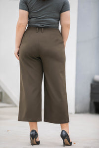 back view of plus size dark green wide legged crop pants
