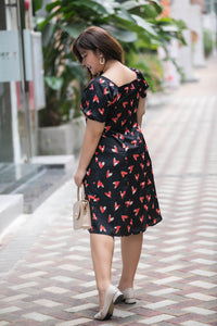back view of plus size black and red heart print satin midi dress with puff sleeves
