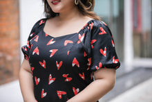 Load image into Gallery viewer, close up of plus size black and red heart print satin midi dress with puff sleeves
