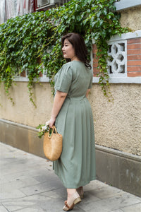back view of plus size green maxi dress with side ties 