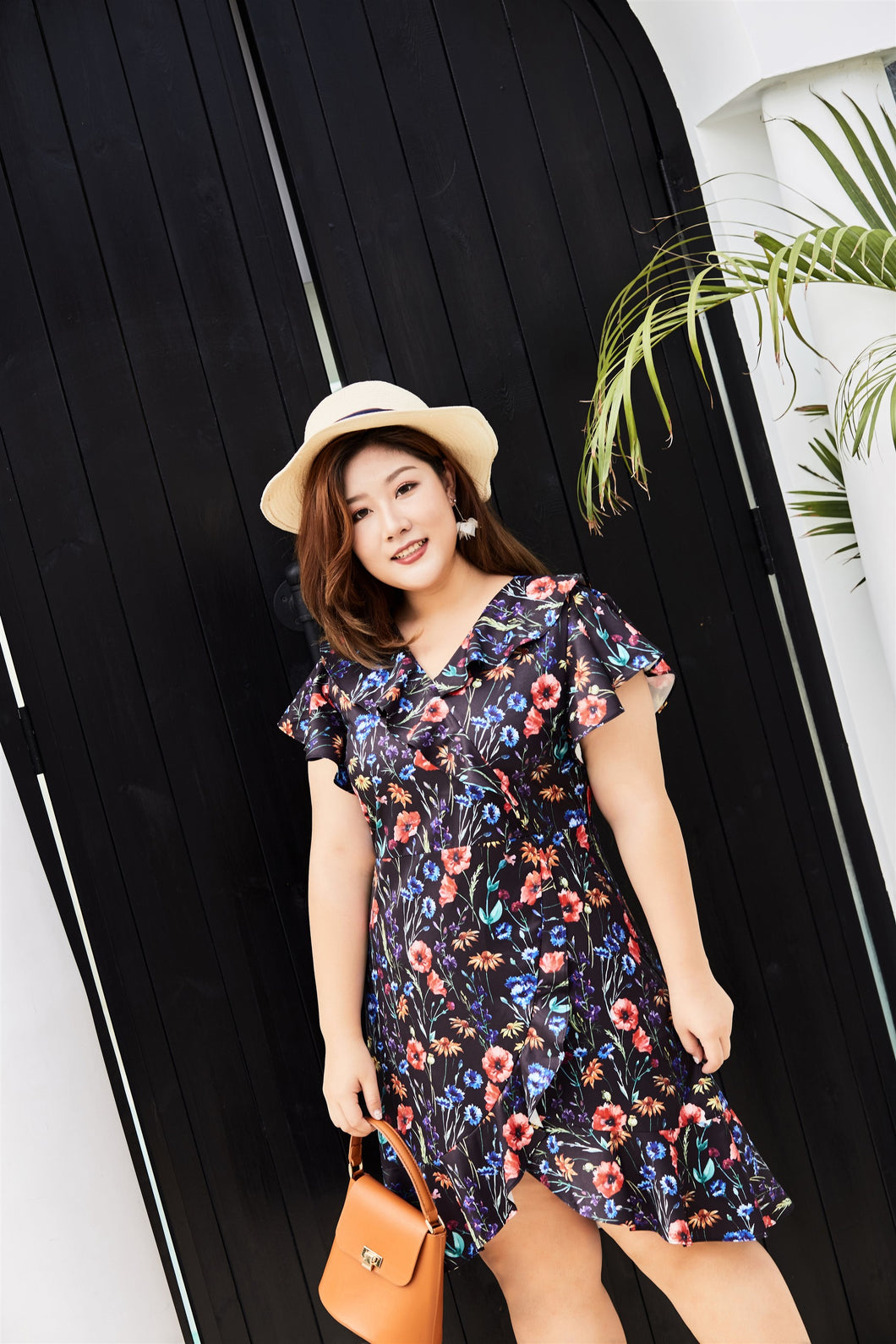 Plus size black floral print faux wrap dress with ruffles