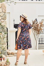 Load image into Gallery viewer, Back view of Plus size black floral print faux wrap dress with ruffles
